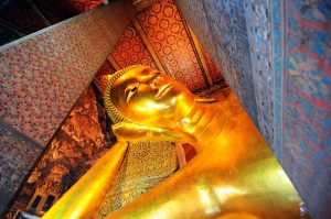 The reclining Buddha statue inside Wat Pho temple in Bangkok, Thailand.