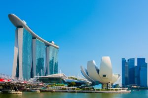 Marina Bay Sands with three tall towers and a large roof structure along the waterfront.