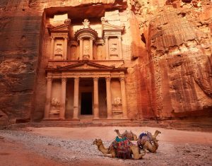 The Treasury of Petra from the front, with its columned façade and resting camels on the forecourt.