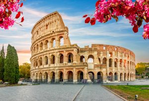 The Colosseum in Rome, Italy, rises as a monumental landmark against the sky.