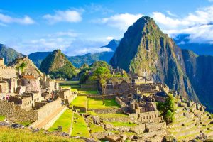 Machu Picchu, the famous Inca ruin city in Peru, sits dramatically on a mountain ridge.