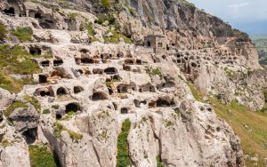 A side angle exterior view of the rock cut city of Vardzia in Georgia.