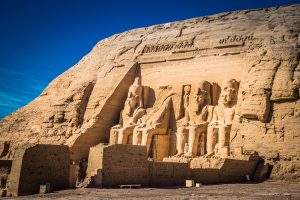 Angled exterior view of the colossal statues at Abu Simbel in Egypt.