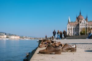 Close-up of Shoes on the Danube Bank with the blurred Parliament Building in the background