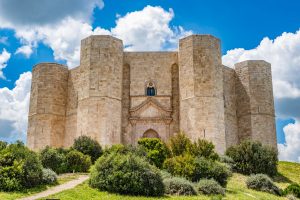 Façade of Castel del Monte with a stone portal and its distinctive octagonal towers.